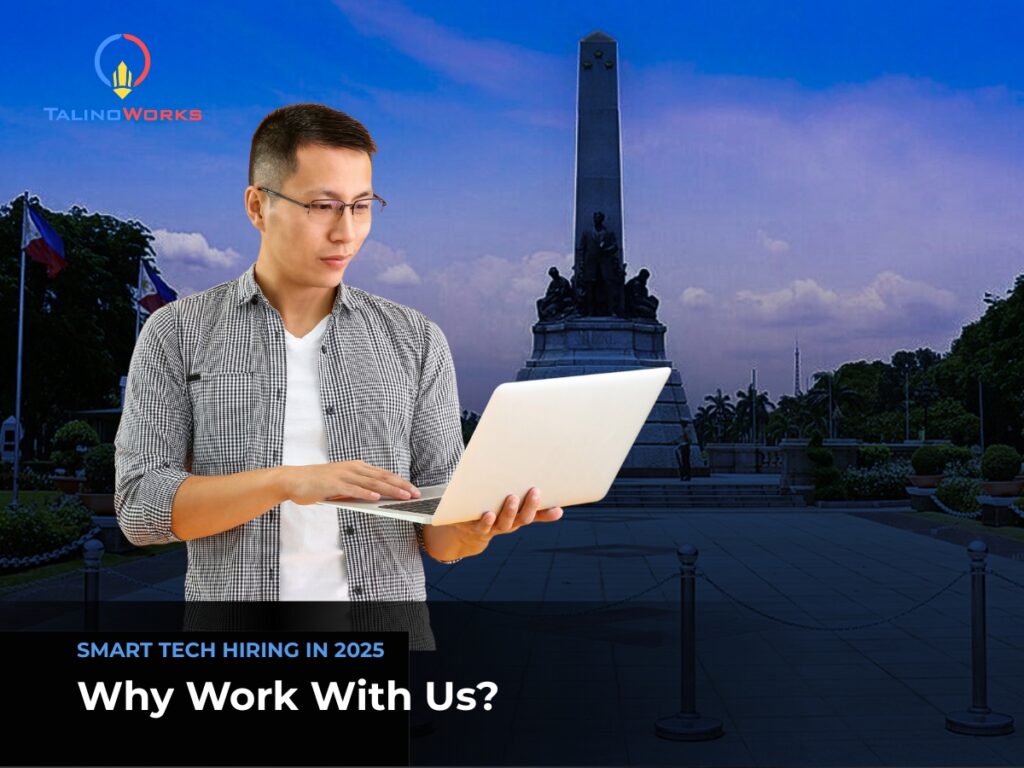 A tech guy with glasses happy looking at his laptop 